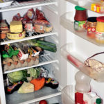 Open Refrigerator Containing Food Products Each Day As Eggs, Butter, Cheese, Sausage, Meat And Vegetables